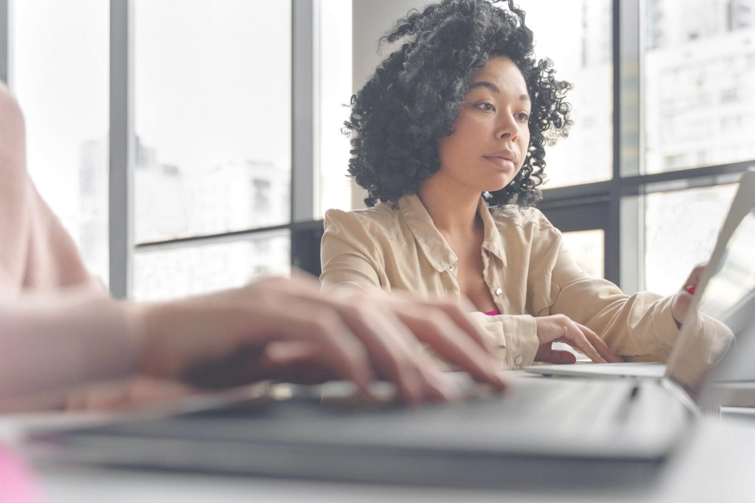 Students collaborating on web design projects in modern learning environment